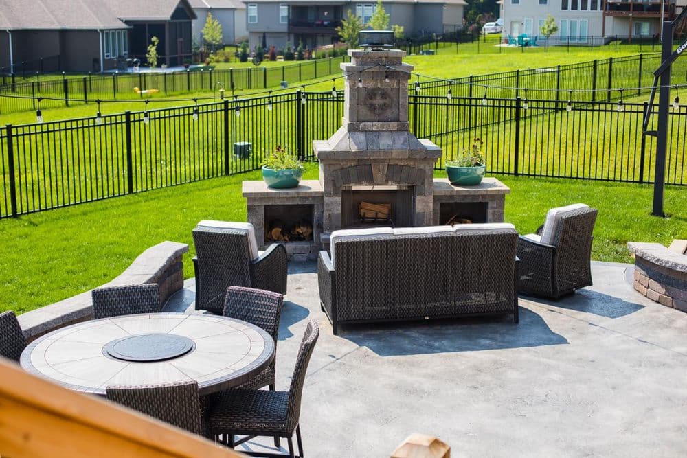Outdoor patio with stone fireplace, seating area